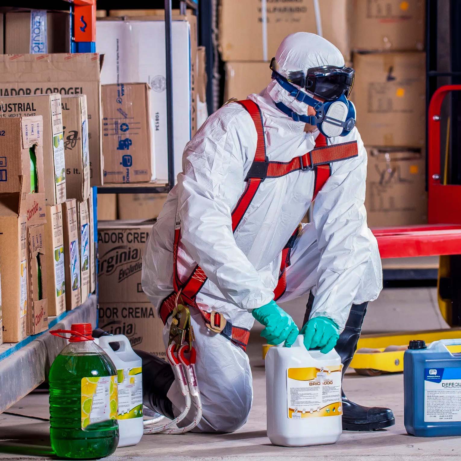Person in protective gear handling chemicals