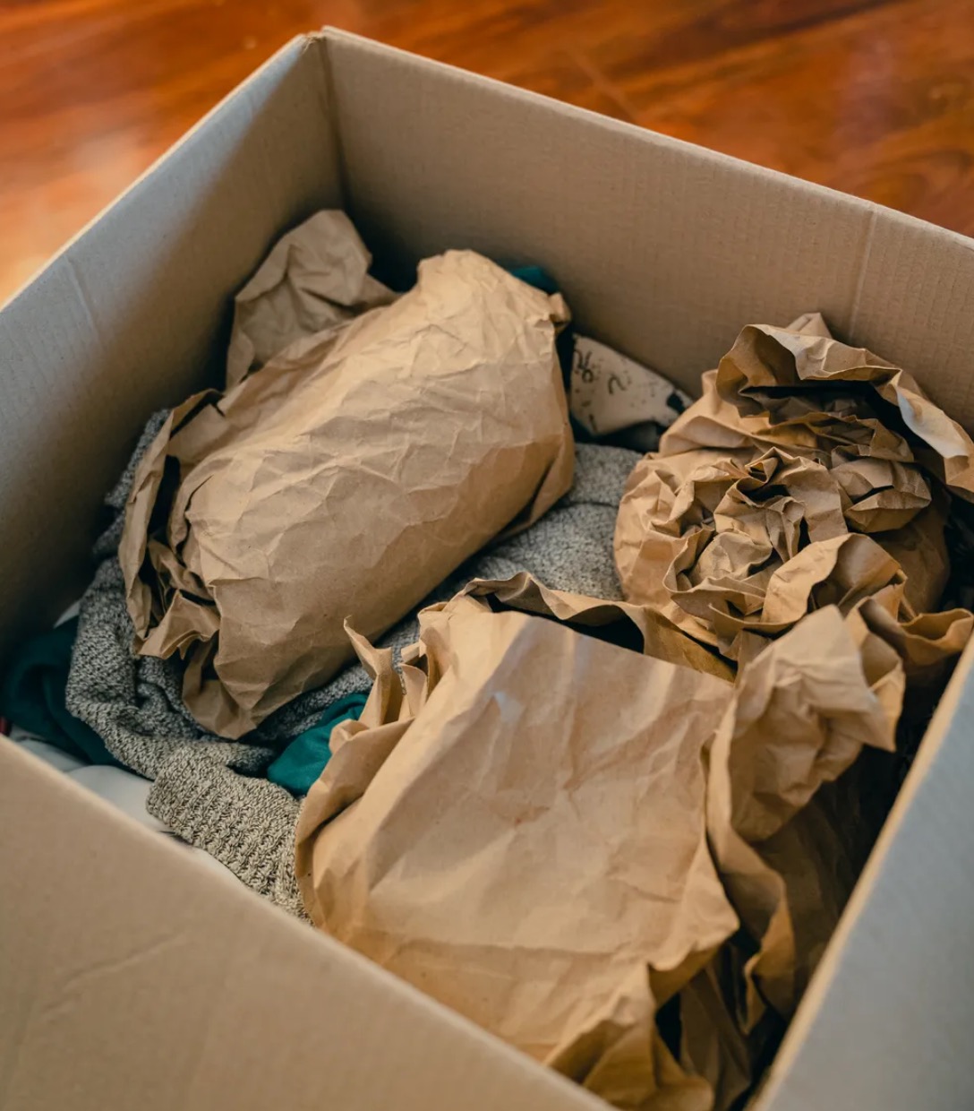 Items wrapped in protective paper and packed in a box